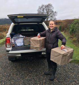 Lara Semple, in-situ Project Officer for Saving Wildcats, holding two traps used for the Trap-Neuter-Vaccinate-Return programme.